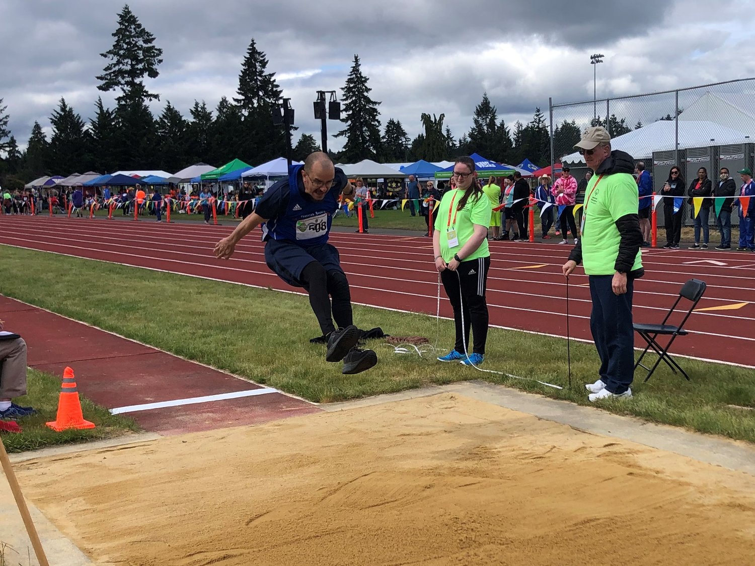 Bruce Voss is shown in mid-air during his final high jump at the Washington State Special Olympics Track and Field Games on Sunday, June 19, 2022.